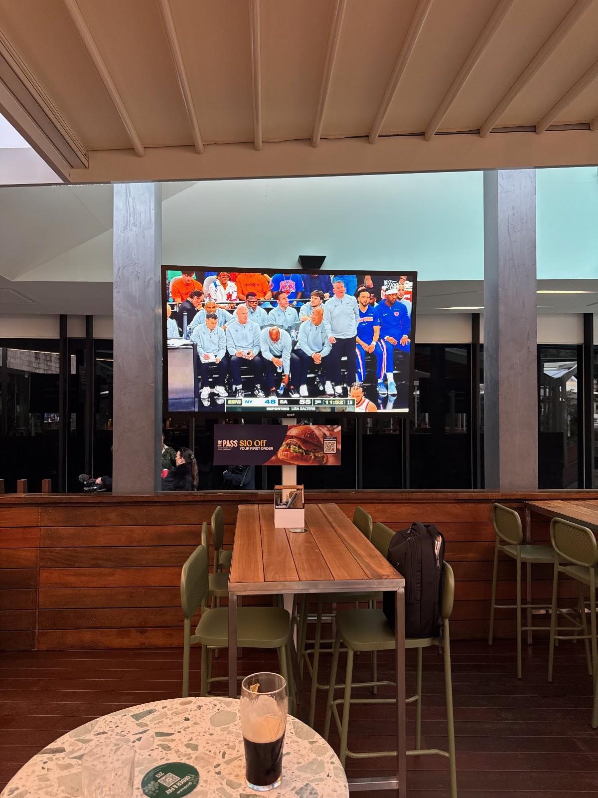 Patrons watching sport on a Spark Element outdoor TV at the Good Nature Hotel